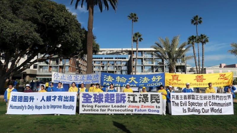 Практикующие Фалуньгун держат плакаты, выстроившись в шеренгу под названием «Великая стена правды». Плакаты сообщают прохожим о репрессиях Фалуньгун в Китае. Фото: minghui.org