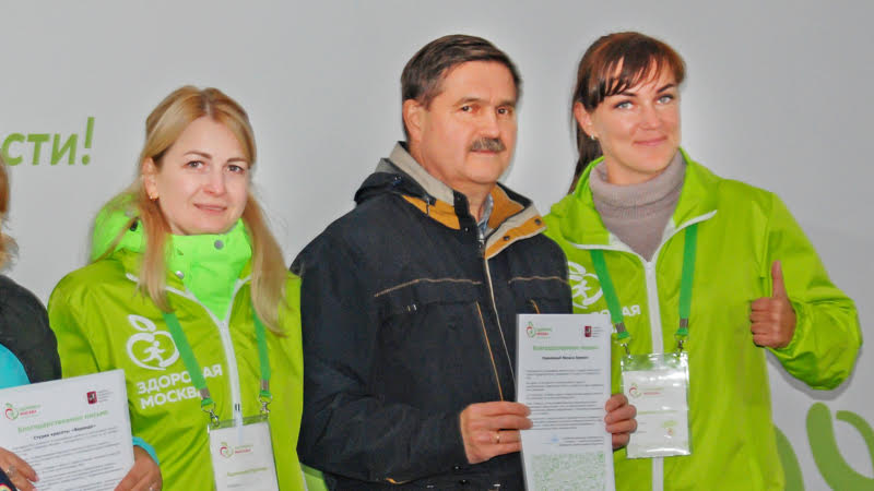 Представители организатора проекта «Здоровая Москва» и Михаил Ерёмин с Благодарственным письмом в руках, сентябрь 2019 г.